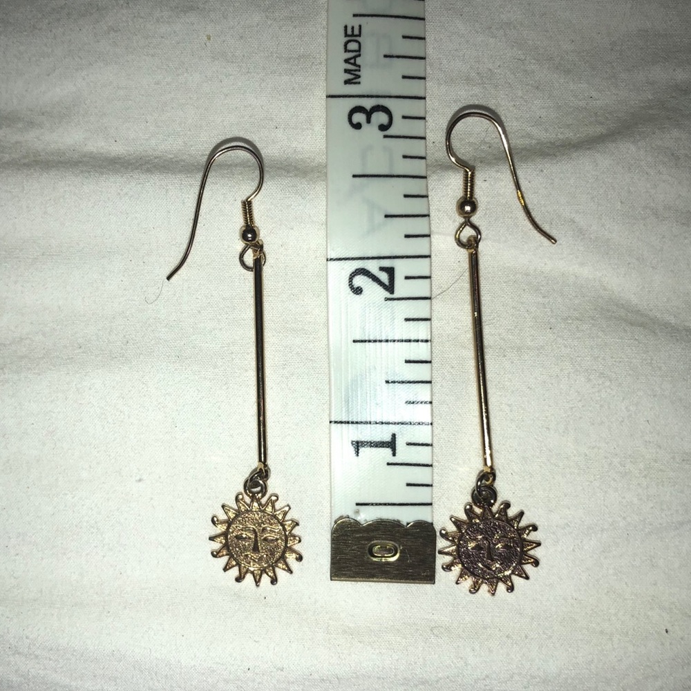 Gold sun face dangle earrings